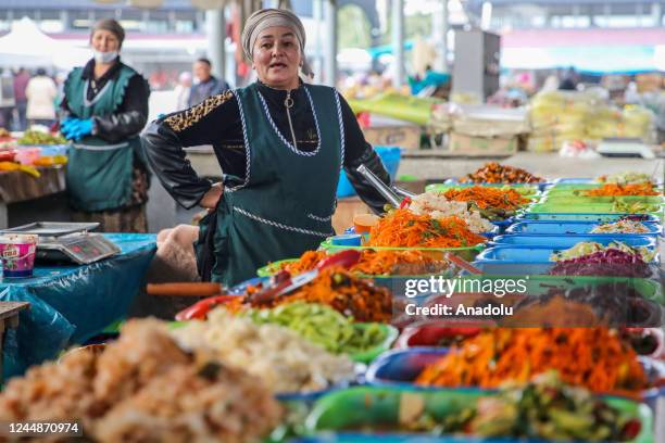 Woman sells handmade pickles and salads at Rishton bazaar as daily life continues in Rishton, Uzbekistan on October 28, 2022.