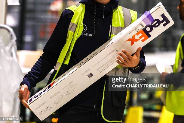 New FedEx hub staff carries a parcel in Colomiers, south-western France, on November 17 as the holiday season approaches.