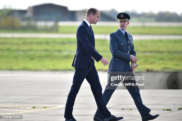 Britain's Prince William, The Prince of Wales walks with Station Commander Billy Cooper during a visit to RAF Coningsby on November 18, 2022 in...