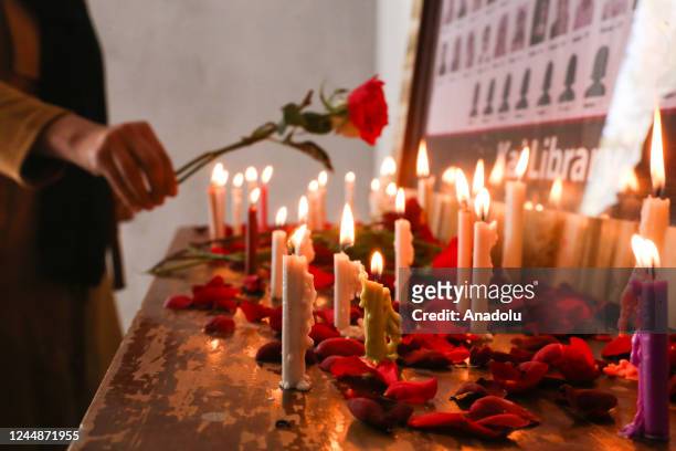 Girl lays a rose to the memory corner at a library dedicated to the victims of Sep. 30 suicide bombing in Kabul, Afghanistan on November 12, 2022....