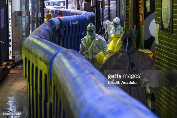 Medical staff with protective clothing are seen inside the fence on November 18, 2022 in Guangzhou,Guangdong province of China. According to official...