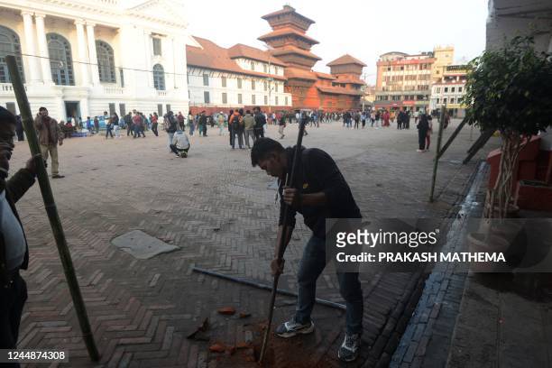 Workers prepare a polling booth ahead of the Nepal's upcoming general election, in Kathmandu on November 18, 2022.