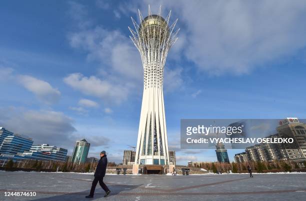 Man walks past the Baiterek observation tower in central Astana on November 18 ahead of Kazakhstan's presidential elections on November 20. -...