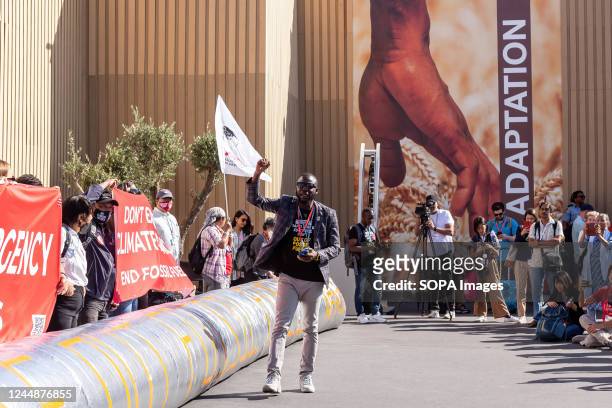 Activists protest and demand phasing out of fossil fuels on the final day of the COP27 UN Climate Change Conference, held by UNFCCC in Sharm...