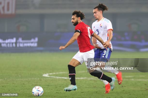 Belgium's defender Arthur Theate marks Egypt's forward Mohamed Salah during the friendly football match between Belgium and Egypt at the Jaber...