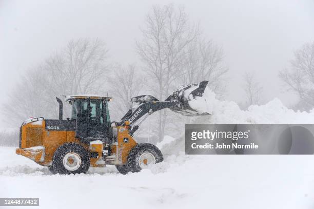 November 18: A loader digs out a parking lot after an intense lake-effect snowstorm impacted the area on November 18, 2022 in Hamburg, New York....