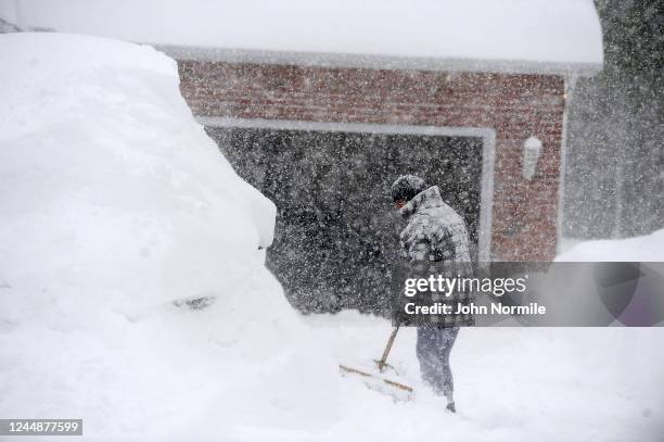 November 18: Michelle Kucalski digs out her car after an intense lake-effect snowstorm impacted the area on November 18, 2022 in Hamburg, New York....