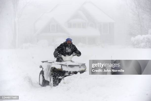 November 18: Robert Skimin uses an ATV to dig out after an intense lake-effect snowstorm impacted the area on November 18, 2022 in Hamburg, New York....