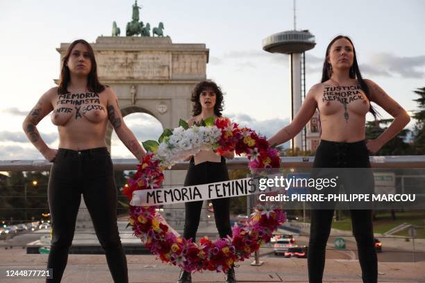 Members of the feminist activist group Femen stage a performance to draw attention on the women victims of the Franco era in front of the Arco de la...
