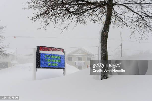 November 18: Snow piles up around signage after an intense lake-effect snowstorm impacted the area on November 18, 2022 in Hamburg, New York. Around...