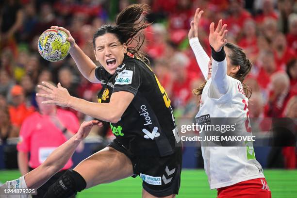 Montenegro's Itana Grbic vies with Denmark's Louise Vinter Burgaard during the EHF Women's handball European Championship semi final between Denmark...