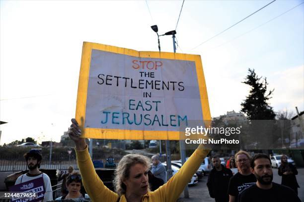 Protesters raise placards and Palestinian flags during a rally organised by foreign and Palestinian activists in the Israeli-annexed east Jerusalem...