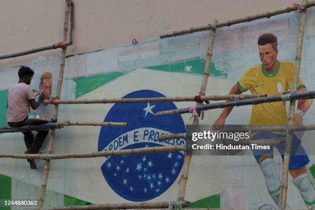 An artist paints a mural of Brazilian footballer Neymar at Gopal Nagar ahead of Qatar Football World Cup 2022 on November 18, 2022 in Kolkata, India.