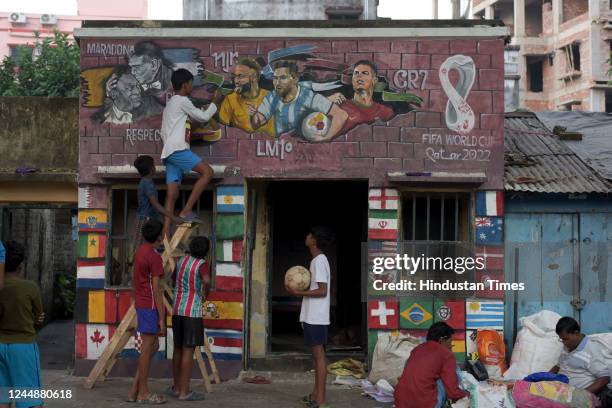 An artist paints murals of global footballers at Chetla ahead of Qatar Football World Cup 2022 on November 18, 2022 in Kolkata, India.