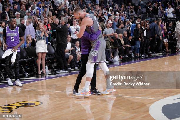 Sacramento Kings owner and chairman Vivek Ranadive and Domantas Sabonis of the Sacramento Kings hug after defeating the Golden State Warriors on...