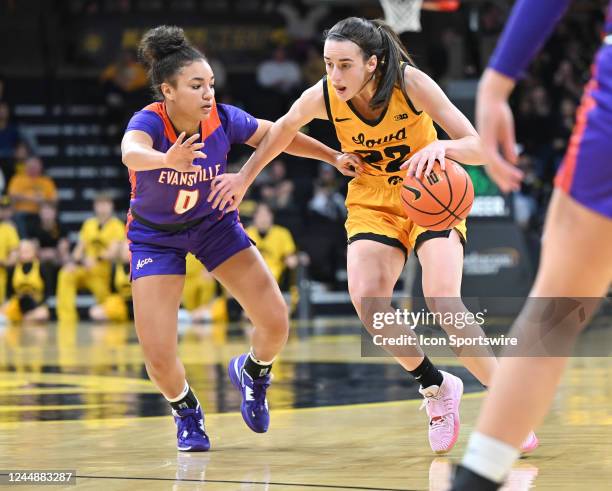 Evansville guard Kynidi Mason Striverson tightly guards Iowa guard Caitlin Clark during a women's college basketball game between the Evansville Aces...