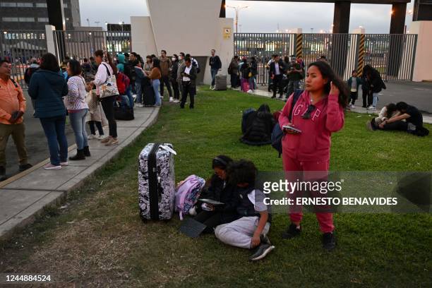 People who lost their flights remain outside the closed Jorge Chavez International Airport after the accident of the LA2213 flight in Lima, on...