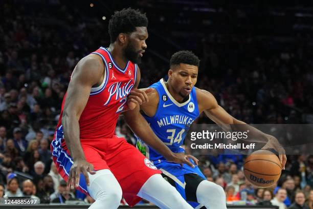 Giannis Antetokounmpo of the Milwaukee Bucks drives to the basket against Joel Embiid of the Philadelphia 76ers in the first quarter at the Wells...