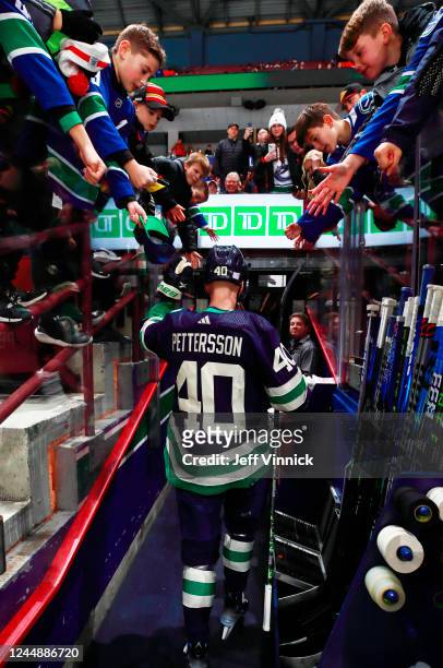 Elias Pettersson of the Vancouver Canucks is greeted by fans during warmup before their NHL game against the Los Angeles Kings at Rogers Arena...