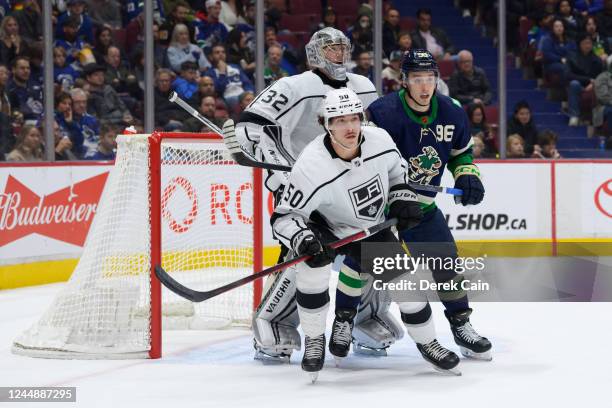 Jonathan Quick and Sean Durzi of the Los Angeles Kings defend against Andrei Kuzmenko of the Vancouver Canucks during the first period of their NHL...