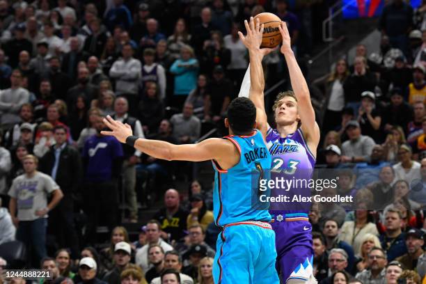 Lauri Markkanen of the Utah Jazz shoots over Devin Booker of the Phoenix Suns during a game at Vivint Arena on November 18, 2022 in Salt Lake City,...