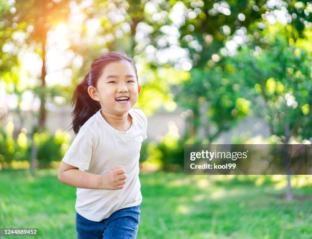 cute little girl running - chinese girl stock pictures, royalty-free photos & images