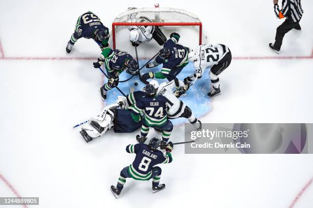 Thatcher Demko Ethan Bear Bo Horvat Conor Garland and J.T. Miller of the Vancouver Canucks battle for the puck with Kevin Fiala Anze Kopitar and Carl...