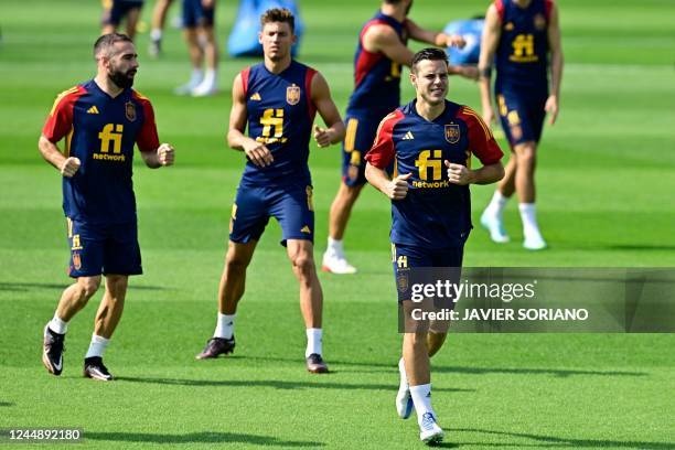 Spain's defender Dani Carvajal , midfielder Marcos Llorente and defender Cesar Azpilicueta attend a training session at the Qatar University training...