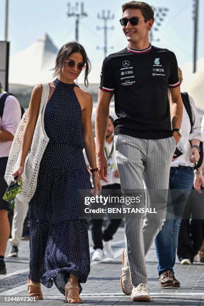 Mercedes' British driver George Russell and his partner Carmen Montero Mundt arrive the third practice session ahead of the Abu Dhabi Formula One...