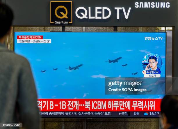 Screen shows a file image of the US and South Korea joint drill during a news program at the Yongsan Railway Station in Seoul. North Korean leader...