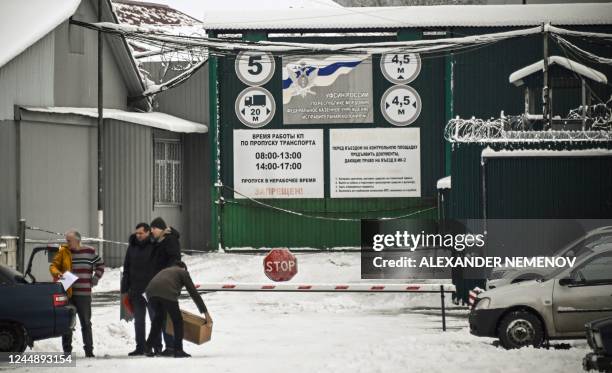 Visitors download a gear at the entrance of the penalty colony IK-2 in the town of Yavas in Mordovia, central Russia, on November 19, 2022. - US'...