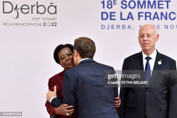 Tunisia's President Kais Saied looks on as the secretary general of the Organisation Internationale de la Francophonie Louise Mushikiwabo embraces...