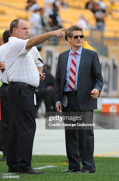 General Manager Kevin Colbert of the Pittsburgh Steelers points as he talks with General Manager Thomas Dimitroff of the Atlanta Falcons before a...