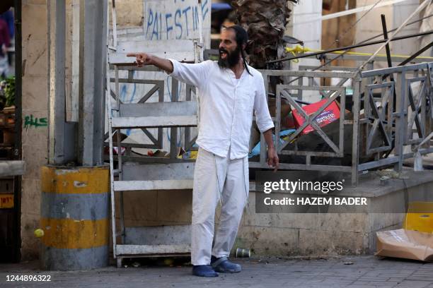 Jewish settler shouts at Palestinian residents, on his way to visit the tomb of Othniel ben Kenaz in the area H1 , in the occupied West Bank city of...