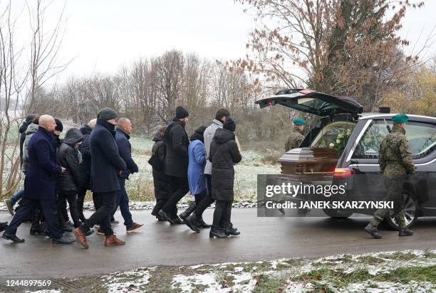 Mourners walk behind the coffin of one of two victims of a missile that hit a southeastern Polish village near the border with Ukraine, during the...