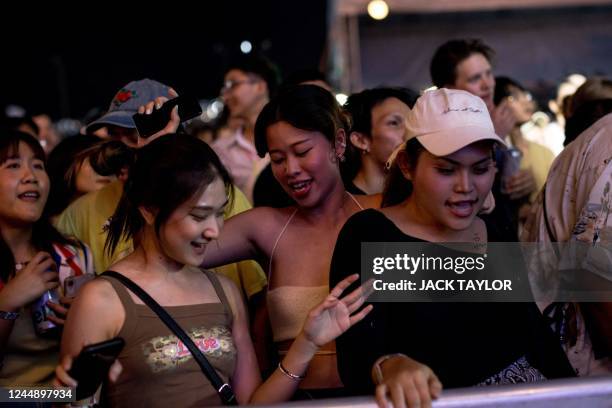 Revellers dance during a performance at Maho Rasop music festival in Bangkok on November 19, 2022.