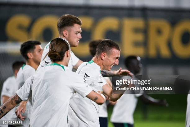 Australia's Mitchell Duke laughs as he takes part in a training session at the Aspire Academy in Doha on November 19 ahead of the Qatar 2022 World...