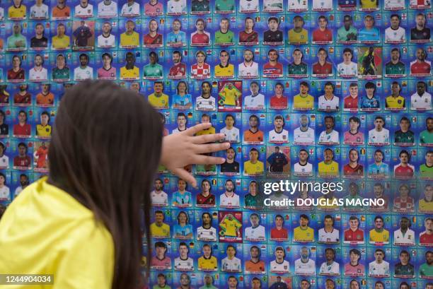 Girl glues Panini World Cup football stickers in the fuselage of a disused plane at a shopping mall in Contagem, Minas Gerais state, Brazil, on...