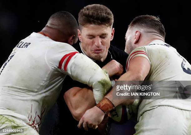 New Zealand's fly-half Beauden Barrett is tackled by England's prop Kyle Sinckler and England's hooker Luke Cowan-Dickie during the Autumn Nations...