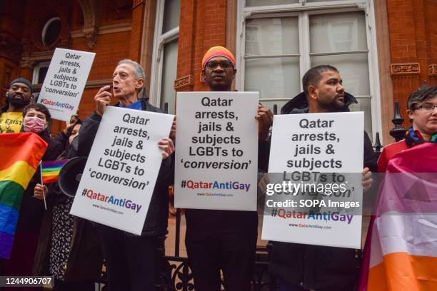 Activist Peter Tatchell holds a placard which states 'Qatar arrests, jails and subjects LGBTs to conversion' while giving a speech during the...