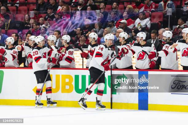 New Jersey Devils Right Wing Nathan Bastian skates by the bench to celebrate his goal followed by New Jersey Devils Center Michael McLeod during...