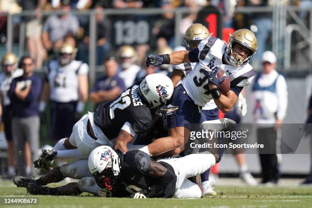 Navy Midshipmen fullback Anton Hall Jr. Tries to fights through multiple defenders during the game between the Navy Midshipmen and the UCF Knights on...