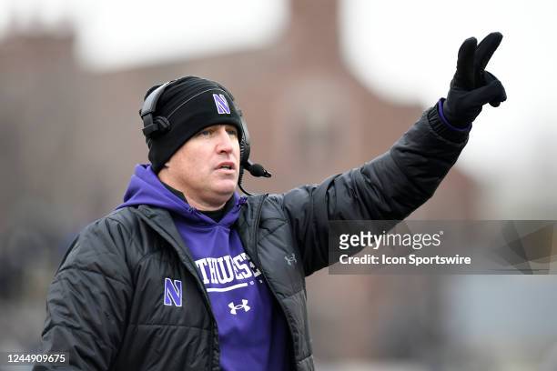 Northwestern Wildcats head coach Pat Fitzgerald signals to go for two during the college football game between the Northwestern Wildcats and the...