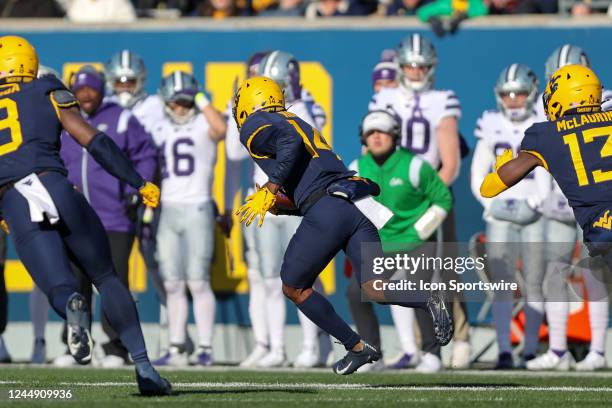 West Virginia Mountaineers safety Malachi Ruffin returns an interception for a touchdown during the first quarter of the college football game...