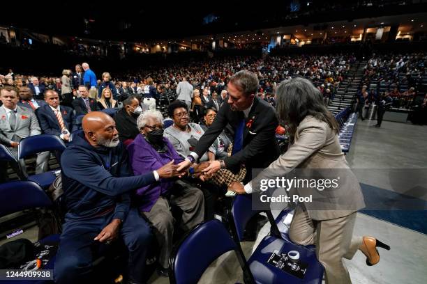 Virginia Attorney General Jason Miyares, second from right, and Virginia Lt. Gov. Winsome Sears, right, greet family members of the deceased before a...