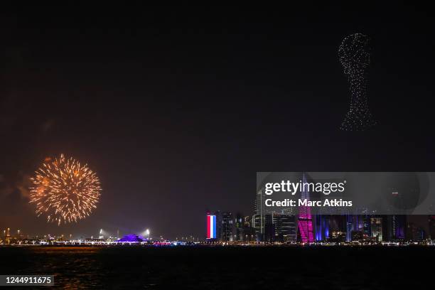 Fireworks and a drone show depicting the FIFA World Cup Trophy are seen over the Doha skyline as the FIFA Fan Festival is opened ahead ahead of the...