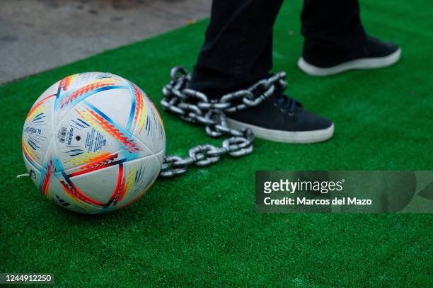 Football ball is seen chained to the leg of a protester during a demonstration against the FIFA World Cup Qatar 2022. People gathered to protest...