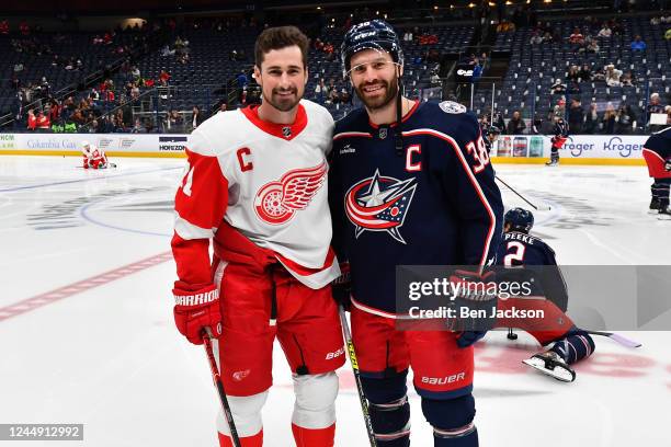 Dylan Larkin of the Detroit Red Wings and Boone Jenner of the Columbus Blue Jackets pose for a photo during warmups prior to a game at Nationwide...