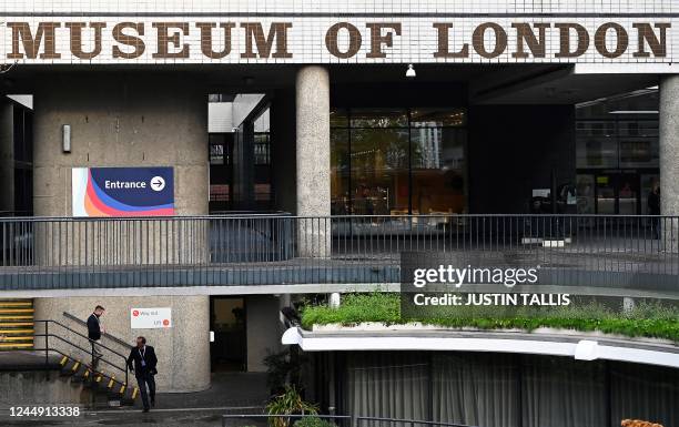 Two men walk past the entrabce of the Museum of London, in London, on November,8 2022. - King Charles I's execution vest and 20,000 human remains are...