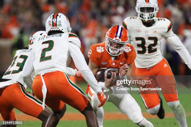 Clemson Tigers quarterback Cade Klubnik braces for contact with defenders during a college football game between the Miami Hurricanes and the Clemson...